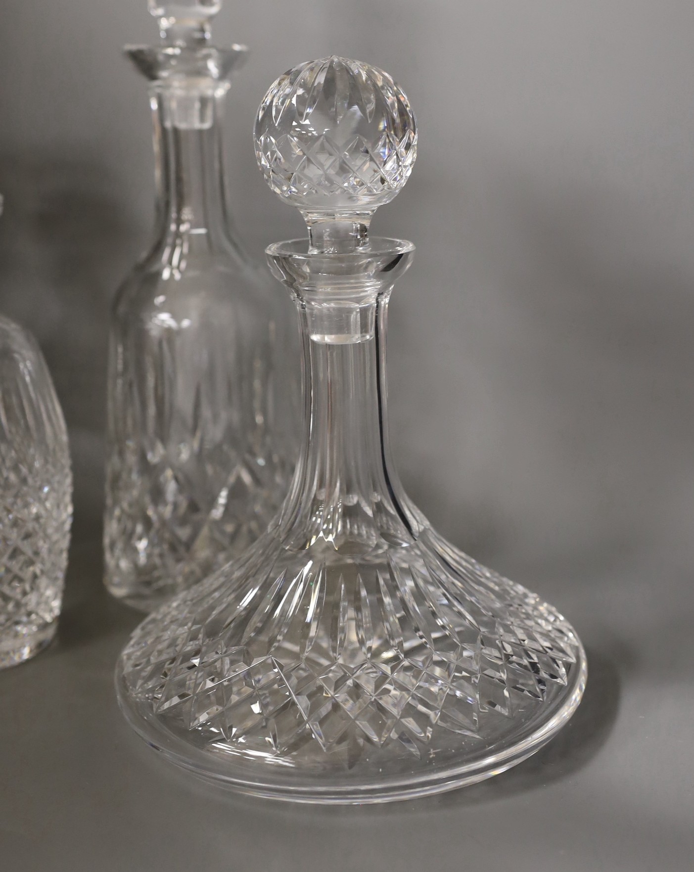 Two Waterford glass decanters, and three other decanters